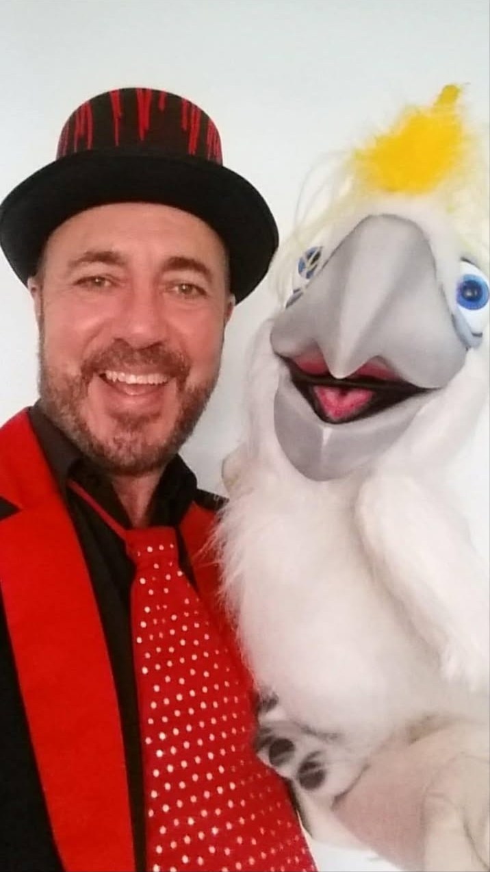 The Amazing Mr Twist Magician with red top hat and live dove