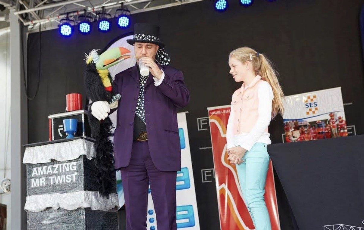 Percy the parrot puppet on stage with a volunteer